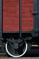 The side of the old brown wooden freight car with the wheel of the times of the Soviet Union photo