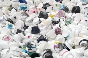 A pattern of many used and soiled nozzles from spray cans with aerosol paint. Background texture of the street art of drawing graffiti on the walls photo