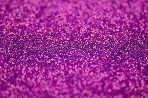 Pink decorative sequins. Background image with shiny bokeh lights from small elements photo