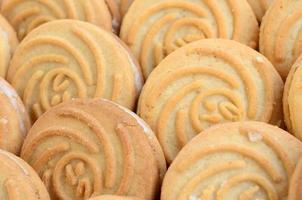 Close-up of a large number of round cookies with coconut filling photo