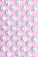 Colorful marshmallow laid out on pink paper background photo