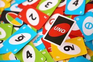 TERNOPIL, UKRAINE - MAY 15, 2022 Many colorful UNO game cards. UNO is an American shedding-type card game that is played with a specially printed deck photo