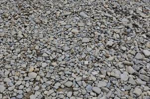Texture of many crushed stones. Crushed stone is a solid base material for foundation photo