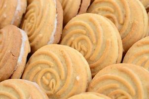 Close-up of a large number of round cookies with coconut filling photo