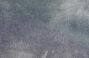 cierre de tejido de malla transpirable de textura en la mochila fotográfica negra. textura de bolsa de tejido de plástico negro. imagen de fondo foto