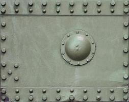 The texture of the wall of the tank, made of metal and reinforced with a multitude of bolts and rivets. Images of the covering of a combat vehicle from the Second World War photo