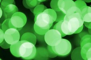 Green abstract Christmas blurred luminous background. Defocused artistic bokeh lights image photo