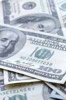 Abstract backdrop with many hundred dollar bills close up photo