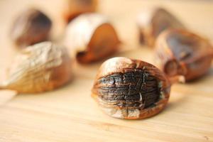 close up pf black garlic on white background table photo