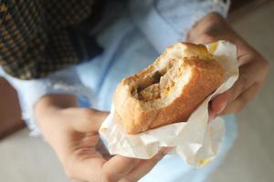 women hand holding beef burger top view photo