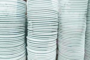 stack of many white color plate on table photo