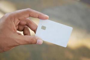 close up of person hand holding credit card photo