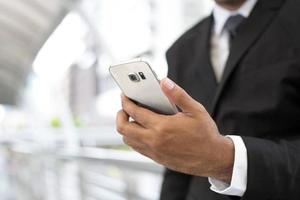 close up hand of young man using mobile smart phone. or Business man Contact Customer. photo