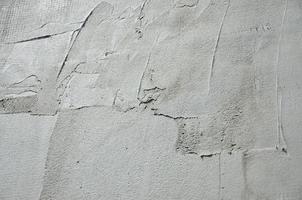 The texture of the wall, covered with gray foam polystyrene plates, which are smeared with a reinforcing mixture. Stage of wall insulation photo