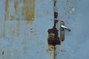 Metal surface from the outer old door with a lock photo