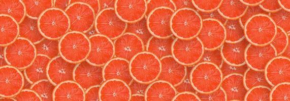 Pattern of red grapefruit citrus slices. Citrus flat lay photo
