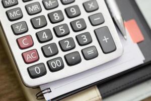 Calculator on table with numbers. Business and Finance accounting concept. photo