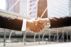 Closeup of a businessman hand shake investor between two colleagues  OK, succeed in business Holding hands. photo