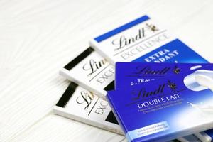 KHARKIV, UKRAINE - DECEMBER 18, 2020 Lindt Chocolate on white background. Lindt and Spruengli AG is a Swiss chocolatier and confectionery company known for their chocolate bars photo