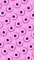 Many small plastic donuts lies on a pastel colorful background. Flat lay minimal pattern. Top view photo