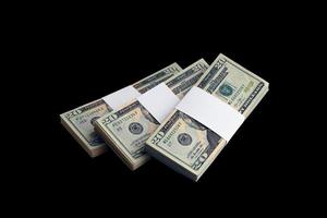 Bundle of US dollar bills isolated on black. Pack of american money with high resolution on perfect black background photo