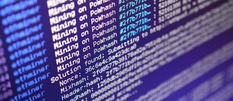 Macro snapshot of the program interface for crypto currency mining on the monitor of an office computer. The concept of mining bitcoins. The flow of information strings and data photo
