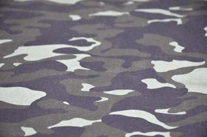 Texture of fabric with a camouflage painted in colors of the marsh. Army background image photo