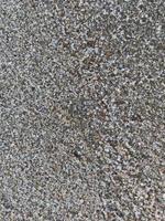 This is a picture of a background of sand on the beach that has just been washed away by the waves photo