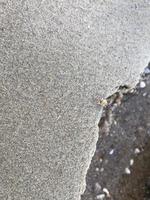 This is a picture of a background of sand on the beach that has just been washed away by the waves photo