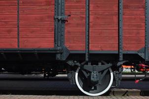 The side of the old brown wooden freight car with the wheel of the times of the Soviet Union photo