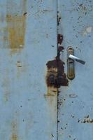 Metal surface from the outer old door with a lock photo