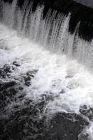 A picture of the flowing water. The dam is designed to regulate the water level in rivers within the city and to provide technical water to industrial objects photo