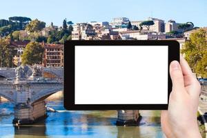 tourist photographs bridge on Tiber River in Rome photo