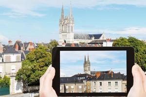 tourist photographs houses and Cathedral in Angers photo