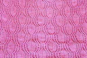 background from hand-knitted pink fabric photo