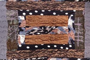 detail of handmade brown patchwork scarf photo