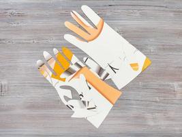 paper models of gloves on wooden table photo