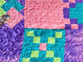 square pieces of fabrics in stitched patchwork photo