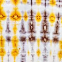 abstract yellow and brown pattern in tie-dye batik photo