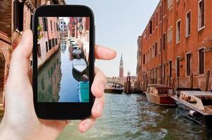 tourist taking photo of Canal and bridge, Venice