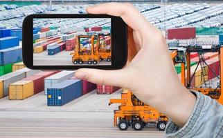 tourist taking photo of freight containers in port