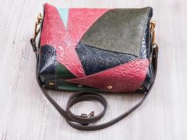 patchwork embossed leather handbag on gray table photo