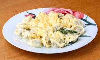 Russian dumplings on the plate and wooden background photo