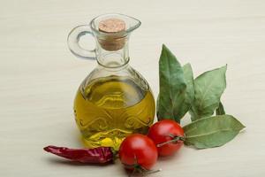 Olive oil on wooden background photo