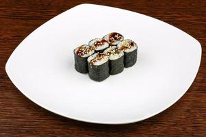 Eel roll on the plate and wooden background photo