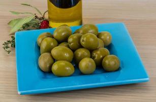 Green olives on wood photo