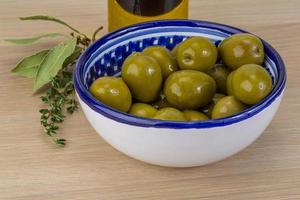 Green olives on wood photo