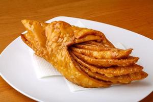 Baklava on the plate and wooden background photo