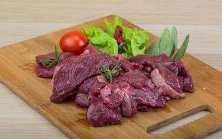 Raw venison on wood photo