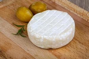 Brie cheese on wood photo